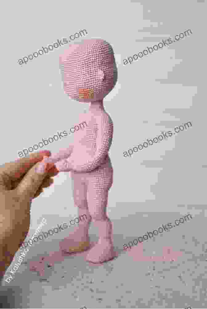 A Crocheted Doll Being Held By A Child, Highlighting The Heartwarming And Comforting Nature Of Amigurumi Dolls Created Using Easy Amigurumi: 28 Doll Patterns (Sayjai S Amigurumi Crochet Patterns 1)