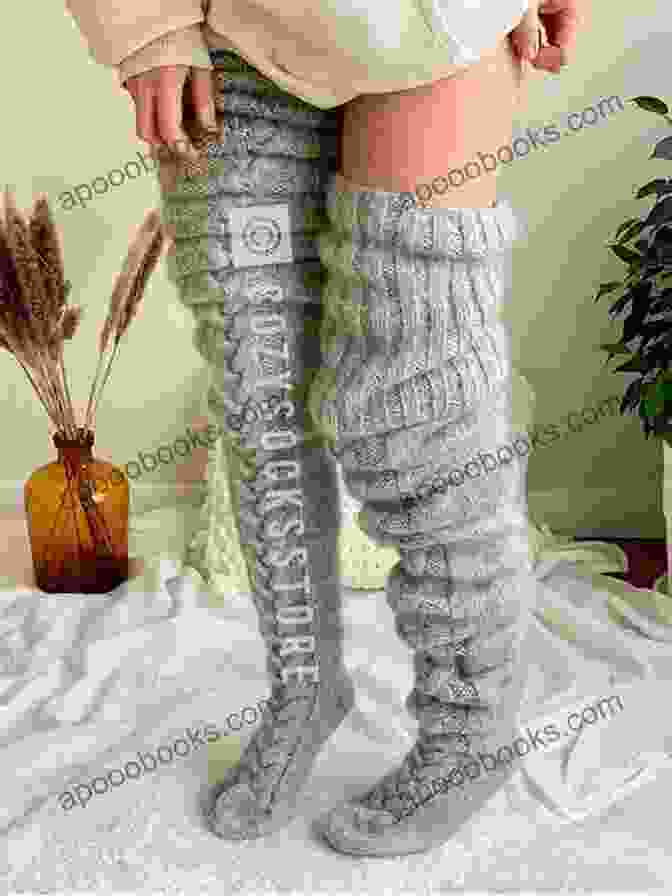 A Pair Of Thigh High Chunky Socks In A Light Gray Color, Photographed On A Wooden Surface. Thigh High Chunky Socks Knitting Pattern