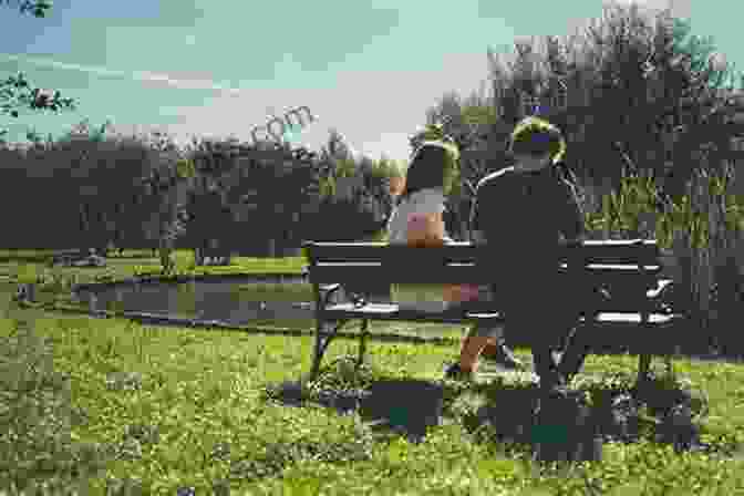 Couple Laughing And Having Fun While Sitting On A Bench In A Park Real Love In Dating: The Truth About Finding The Perfect Partner